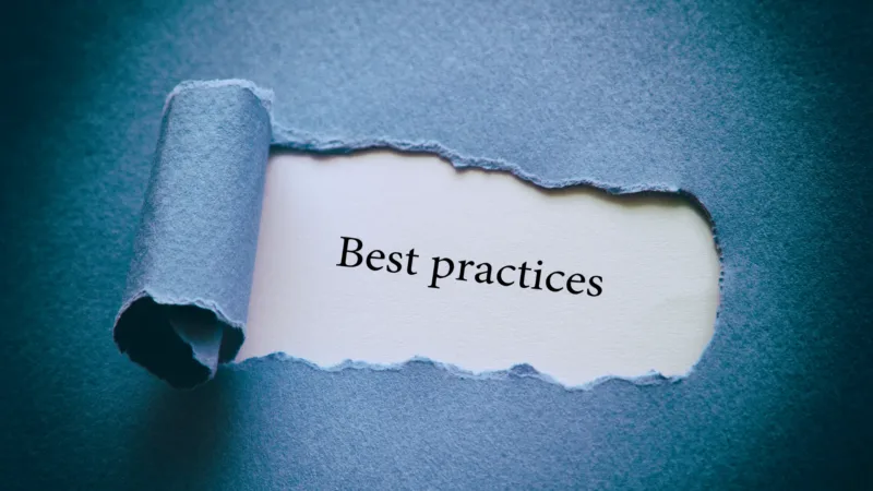 A piece of paper that is blue with a ripped part in the middle that reveals a white piece of paper that has text printed on it that says Best Practices